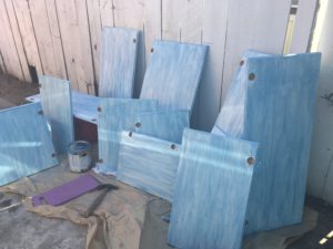 Photos of cabinet doors being painted