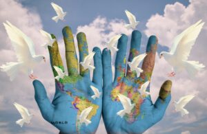 image of hands with world and doves